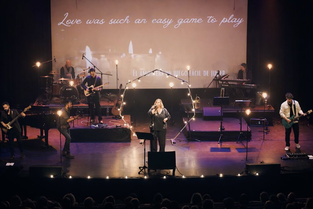 Lady Liverpool actuando en un teatro con proyecciones y luces de escena